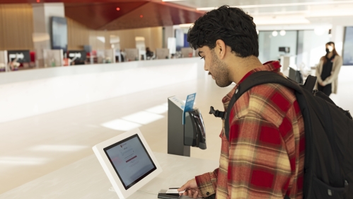 A student logs into a computer in onestop