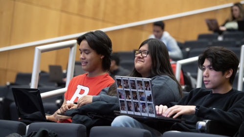 Students sit in a lecture hall course inside the Rutgers Business School.