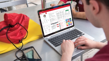 A student types on a laptop on the MyRutgers portal