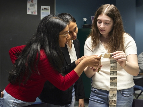 Students in the Hatchery look closely at old photograph archives