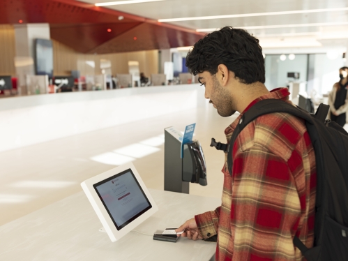 A student logs into a computer in onestop