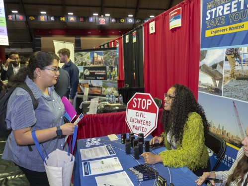 A student talks with prospective employers at the Fall Career & Internship Mega Fair