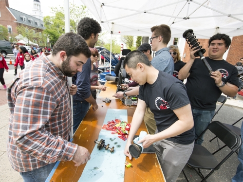 Car Club members table on College Avenue at Rutgers Day demonstrate different car parts