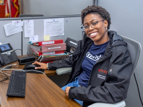 A student worker stands in the Busch Student Center
