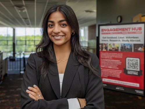 Zenya Kamdar stands in the Student Activities Center on College Avenue campus
