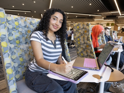 A student studies in a booth at Alexander Library