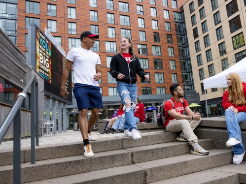 Students walk down steps outside in The Yard